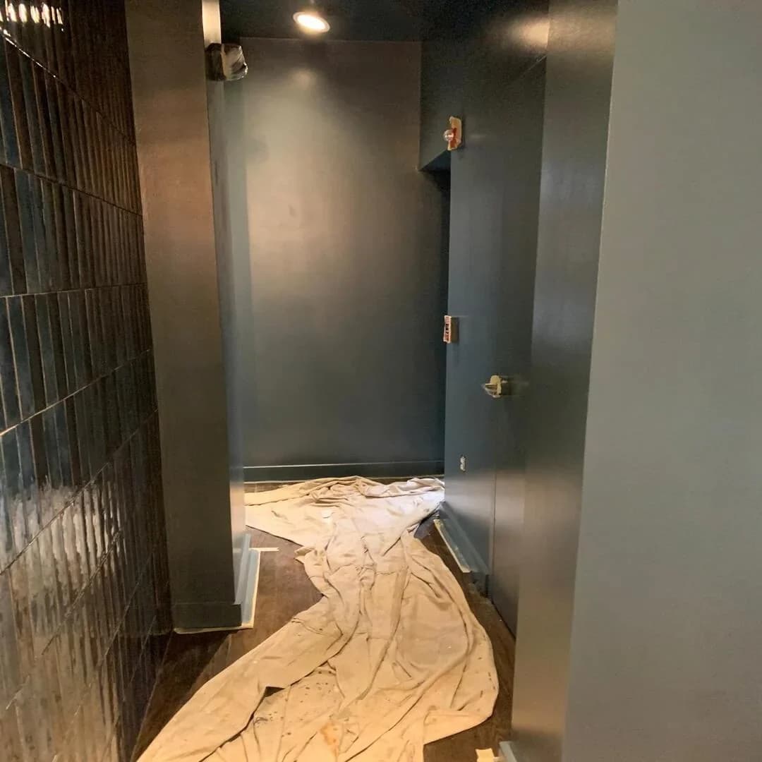 Dark tile feature wall and interior door by JC General Painting in South Florida