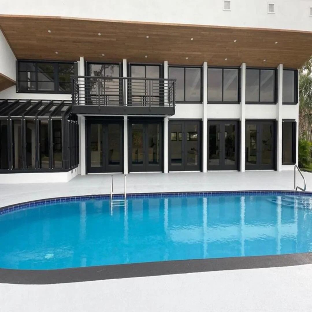 Luxury modern two-story home exterior with pool by JC General Painting in South Florida