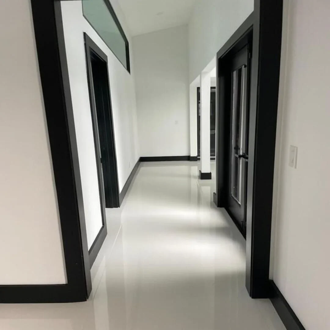 Modern interior hallway with black trim by JC General Painting in South Florida