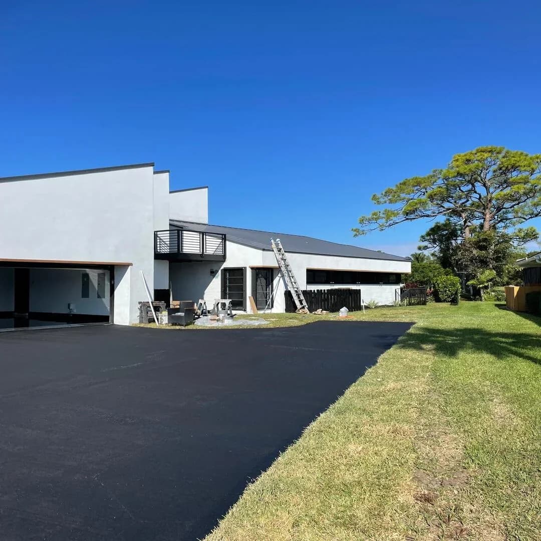 Modern luxury home exterior with new driveway by JC General Painting in South Florida