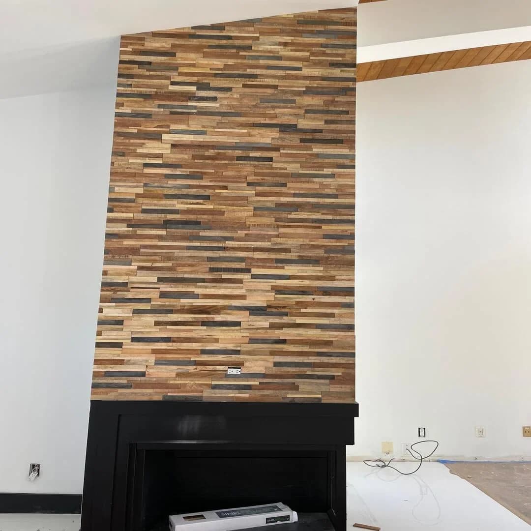 Stacked stone and wood feature wall with fireplace by JC General Painting in South Florida